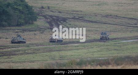 British army Warrior FV512 MRV & Warrior FV510 IFV tanks in action on a military exercise, Salisbury Plain, Wilts UK Stock Photo