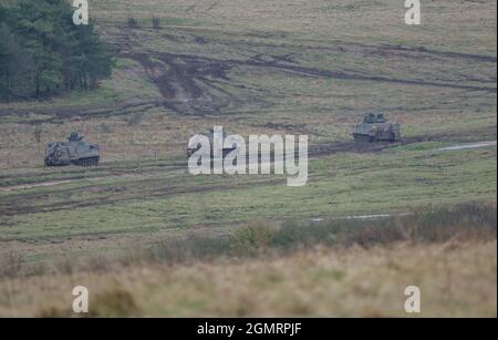 British army Warrior FV512 MRV & Warrior FV510 IFV tanks in action on a military exercise, Salisbury Plain, Wilts UK Stock Photo