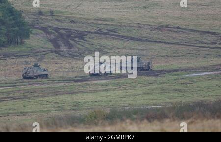 British army Warrior FV512 MRV & Warrior FV510 IFV tanks in action on a military exercise, Salisbury Plain, Wilts UK Stock Photo