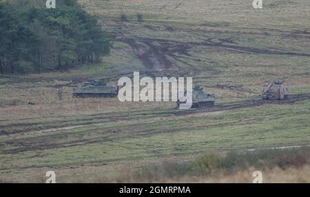 British army Warrior FV512 MRV & Warrior FV510 IFV tanks in action on a military exercise, Salisbury Plain, Wilts UK Stock Photo