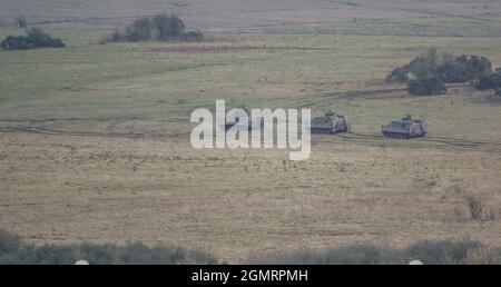 British army Warrior FV512 MRV & Warrior FV510 IFV tanks in action on a military exercise, Salisbury Plain, Wilts UK Stock Photo