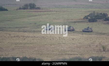 British army Warrior FV512 MRV & Warrior FV510 IFV tanks in action on a military exercise, Salisbury Plain, Wilts UK Stock Photo