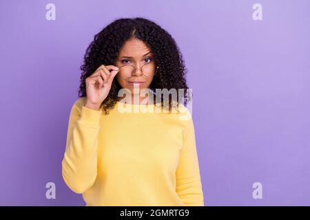 Photo of doubtful funny dark skin girl dressed yellow sweatshirt arm glasses looking you isolated purple color background Stock Photo