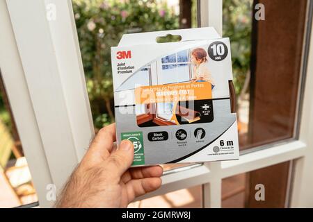 POV male hand holding near the window of new package with 3M Premium Stock Photo