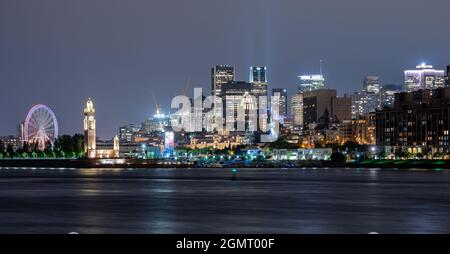 View of downtown Montreal city skyline and Saint Lawrence River at night, Quebec, Canada. Stock Photo