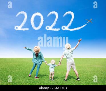 Happy family watching the sky and celebrating new year 2022 concepts