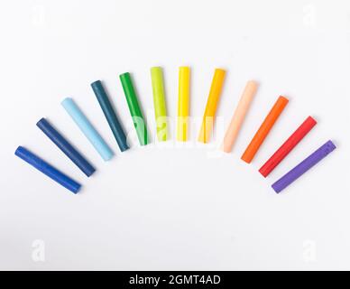 oil pastel crayons arranged in rainbow style on white background Stock Photo