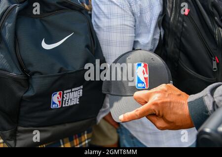 A photographer holds a hat with the NBA logo next to a Nike backpack embroidered with NBA Summer League during a groundbreaking ceremony for the new h Stock Photo