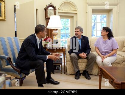 President Barack Obama meets with Richard Phillips, the captain of the U.S. cargo ship that was held hostage by pirates last month, in the Oval Office of the White House on May 9, 2009. Phillips was joined by his wife, Andrea.(Official White House photo by Pete Souza) Stock Photo