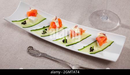 Fresh salad with salmon, two types of cheese and fresh cucumber Stock Photo