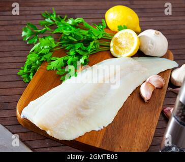 Raw cod fillet before cooking. Isolated over white background Stock ...