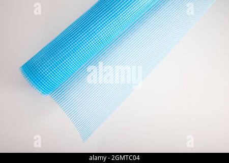 Blue reinforcing construction mesh for wall strengthening on white background, isolate. Stock Photo