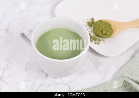 Cup of green tea latte on marble table Stock Photo