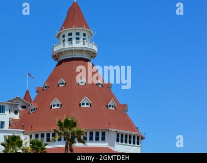 Close up of the unique red turret of the iconic 1888 Queen Anne Victorian style Hotel del Coronado in San Diego, CA against blue sky Stock Photo
