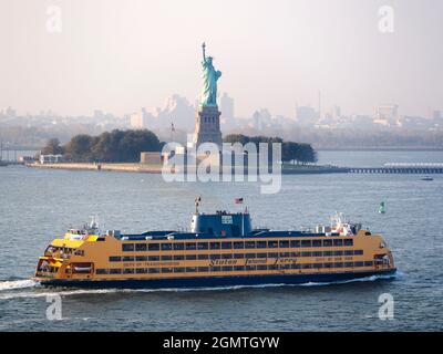 New York, USA -  5 November 2013; an everyday scene in New York Harbour. A Staten Island Ferry cruises past the iconic Statue of Liberty. Stock Photo
