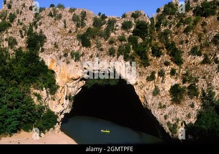 Pont d' Arc limestone bridge, Ardeche, France France -  20; Two (tiny) people in view, canoeing. The Pont d'Arc s a large natural limestone bridge ove Stock Photo