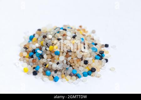 A pile of nurdles collected from the beach on a white background Stock Photo