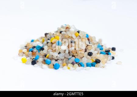 A pile of nurdles collected from the beach on a white background Stock Photo