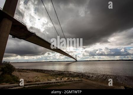 The Humber Bridge, near Kingston upon Hull, East Riding of Yorkshire, England, is a 2.22 km (2,430 yd; 7,300 ft; 1.38 mi) single-span road suspension bridge, which opened to traffic on 24 June 1981. When it opened, the bridge was the longest of its type in the world; it was not surpassed until 1998, with the completion of the Akashi Kaikyō Bridge, and is now the eleventh-longest. It is still the second-longest span in the Western Hemisphere.  The bridge spans the Humber (an estuary formed by the rivers Trent and Ouse), between Barton-upon-Humber on the south bank and Hessle on the north bank. Stock Photo