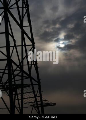 Oxfordshire, England - 31 March 2020; no people in view.    I love electricity pylons; I find their abstract, gaunt shapes endlessly fascinating. Here Stock Photo