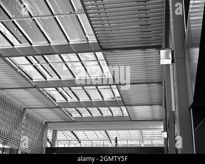 Oxford, England - 18 April 2018; one man on a walkway. Westgate is a new shopping area in Oxford City Centre, England. Opened in  October 2017, it is Stock Photo