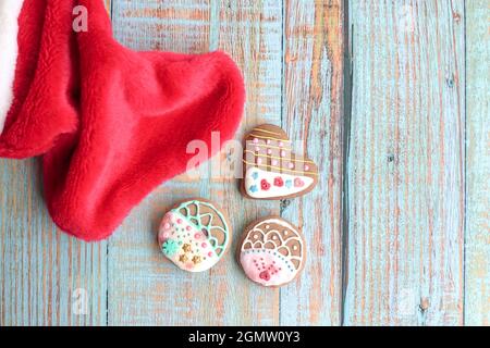 Gingebread cookies on a wood table with santa sock by the side. Top view. Stock Photo