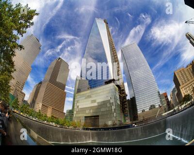 New York, USA - 3 November 2013 An iconic place in an iconic city. Fisheye view of the new One World Trade Centre and Memorial Fountain at Ground Zero Stock Photo