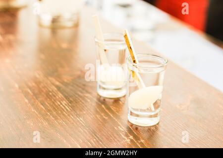 Two refreshing shots of alcohol on wooden table Stock Photo