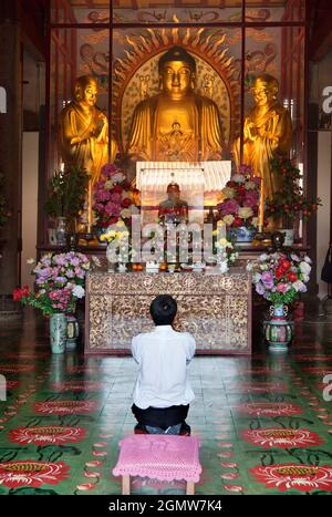 Penang, Malaysia - 7 April 2011; one man praying in view. Overlooking the sea, Kek Lok Si (Heavenly Temple) on Penang Island , is the largest Buddhist Stock Photo