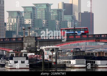 A red bus crosses Lambeth Bridge, London, in the morning. Massive residential developments to the west can be seen in the distance. Stock Photo