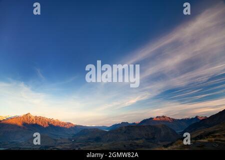 Queenstown, New Zealand - 21 May 2012 Magnificent wilderness. The last rays of sunset illuminate peaks of the Remarkables mountain range above, Queens Stock Photo