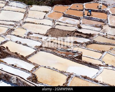Maras, Peru - 12 May 2018; two workers in shot  Maras salt mines have been continuously mined for many centuries since the Empire of the Incas. These Stock Photo
