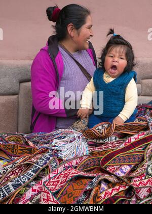Pisac, Peru - 11 May 2018; a mother and child in shot  A happy family scene in Pisac market, close to Cusco, Peru. Stock Photo