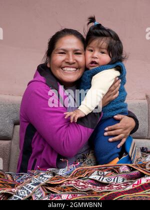 Pisac, Peru - 11 May 2018; a mother and child in shot  A happy family scene in Pisac market, close to Cusco, Peru. Stock Photo