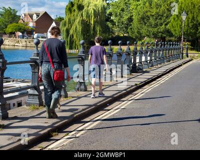 Abingdon, England - 29 July 2020;  Two people in shot. walking, plus concealed dog.... Saint Helen's Wharf is a noted beauty spot on the River Thames, Stock Photo