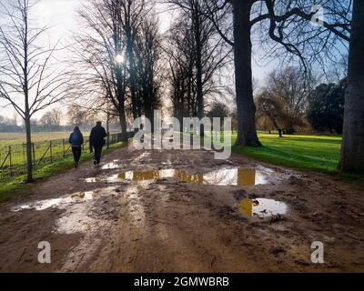 Oxford, England - 11 December 2018; two walkers in shot.   Christ Church College of Oxford University, England, is one of the oldest and grandest coll Stock Photo