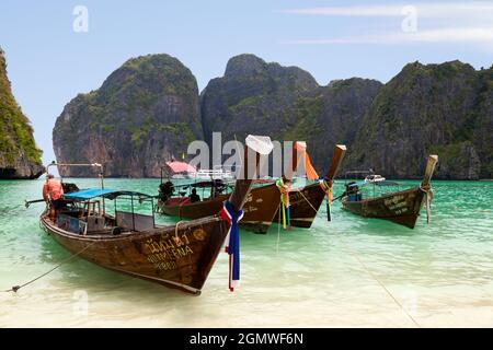 Phuket Island, Thailand - April 2011; Tourist boats moored on the golden beach of Khao Phing Kan Island, Phuket Thailand. Khao Phing Kan is located in Stock Photo