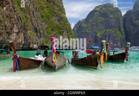 Phuket Island, Thailand - April 2011; Tourist boats moored on the golden beach of Khao Phing Kan Island, Phuket Thailand. Khao Phing Kan is located in Stock Photo