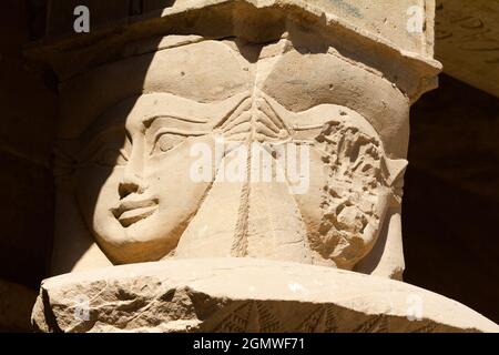 Egypt - 2 December 2010; Figures on a column emerge from shadow at the Philae Temple in Egypt. This temple devoted to Isis was originally located near Stock Photo