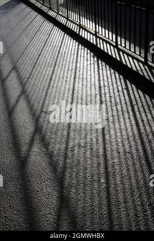 Oxfordshire, England - 22 April 2016 Low-angle sunlight shining through these metal railings in Abbey Fields, Oxfordshire, create this pleasing abstra Stock Photo