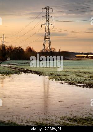 Oxfordshire, England -  30 December 2020; no people in view.    I love electricity pylons; I find their abstract, gaunt shapes endlessly fascinating. Stock Photo