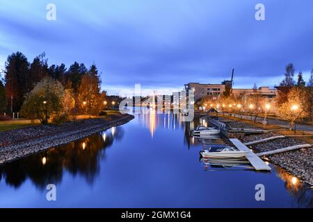 River in the residential neighborhood on an autumn evening, boats docked, Joensuu, Finland. Stock Photo