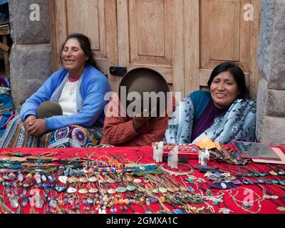 Pisac, Peru - 11 May 2018; three women in shot   Portrait of an old woman in Pisac market, close to Cusco, Peru. Like may women in the area, they wear Stock Photo