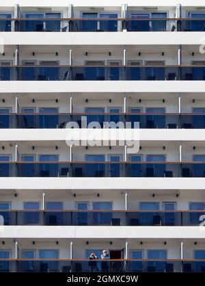 Halifax, Canada - 11 September 2013 Two passengers stare out from a cruise liner moored at Halifax in Nova Scotia, Canada. This is an important stoppi Stock Photo