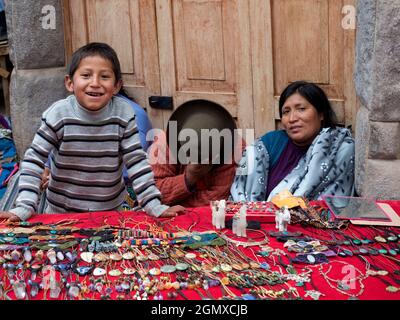 Pisac, Peru - 11 May 2018; two women and a boy in shot   Portrait of an old woman in Pisac market, close to Cusco, Peru. Like may women in the area, t Stock Photo