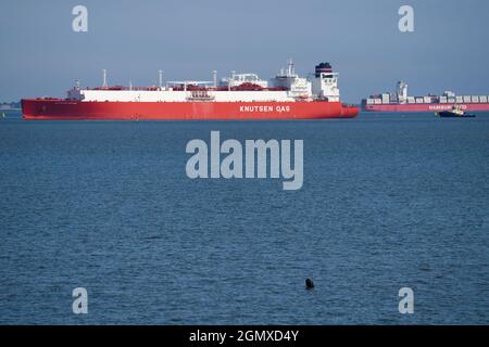 Sheerness, Kent, UK. 21st September, 2021. Two large ships are seen passing close to the infamous shipwreck SS Richard Montgomery (which sank with 1400 tons of explosives onboard) in the Thames Estuary off of Sheerness, Kent this morning. Container ship 'SANTA BARBARA' in the background, with the bow of huge LNG Gas ship 'RIAS BAIXAS KNUTSEN' seen in the foreground, with the shipwreck appearing to be sandwiched in the middle. Credit: James Bell/Alamy Live News Stock Photo