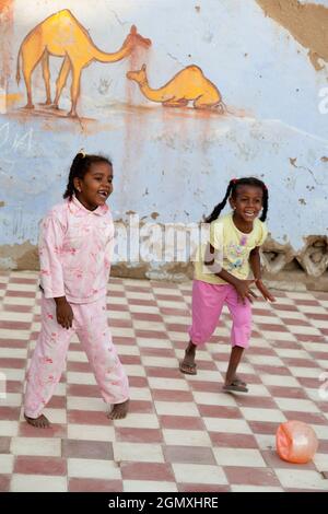 Aswan, Egypt - 3 December 2010; Two small girsl lost in play in a small Nubian village on the west bank of the Nile, close to Aswan. The people there Stock Photo