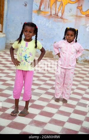 Aswan, Egypt - 3 December 2010; Two small girsl lost in play in a small Nubian village on the west bank of the Nile, close to Aswan. The people there Stock Photo