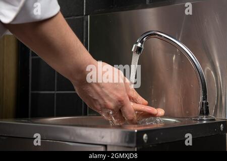 Close up photo of Men washing hands with water Stock Photo - Alamy