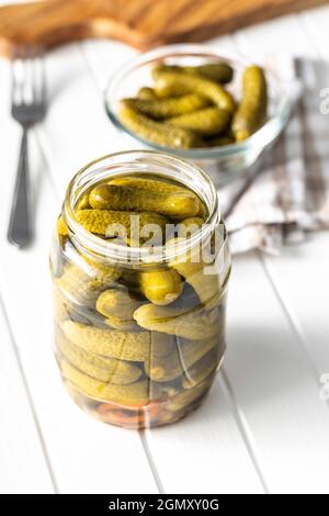 Small pickles. Marinated pickled cucumbers. Stock Photo